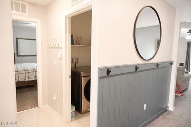 Hall with washer / dryer, carpet floors, and visib