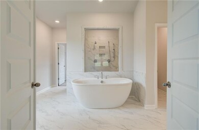 Bathroom with separate shower and tub and tile flooring
