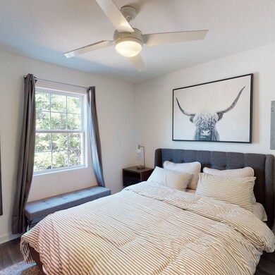 Bedroom featuring dark wood-style floors and ceiling fan