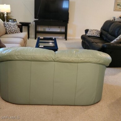 Living room featuring light colored carpet