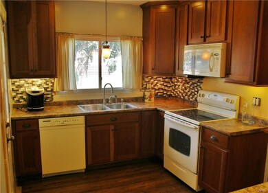 Shaker designed cherry cabinets with glass backspl