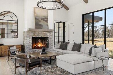 Living room with wood finished floors, a chandeli