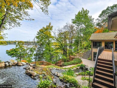 Lushly landscaped with waterfall and pond.