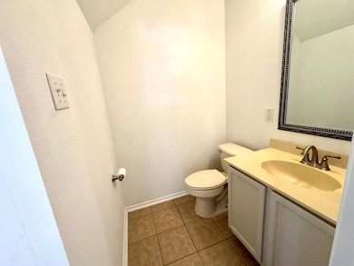 Bathroom with vanity, light tile patterned floors, and a textured ceiling