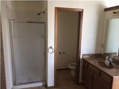 master bathroom with separate room for the toilet.