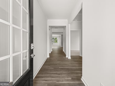 Aria front entryway into the single story home with dark hardwood like flooring