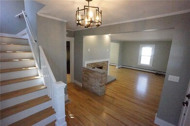 Beautiful front foyer with stairs to...