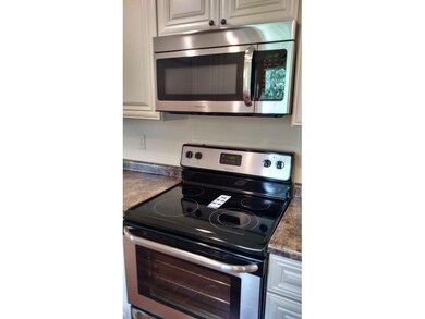 Brand new range with overhead microwave.