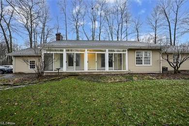 Large sunroom overlooks rear yard.