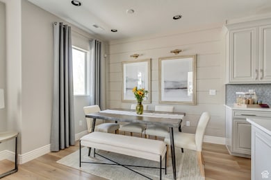PHOTOS FOM SIMILAR MODEL HOME. FINISHES, COLORS, AND OPTIONS WILL VARY. Dining area featuring light wood finished floors and recessed lighting