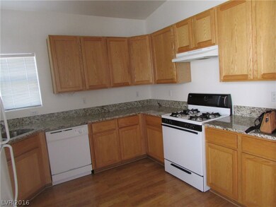 Open kitchen with granite counters.