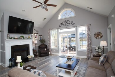 Living room with ceiling fan, high vaulted ceiling