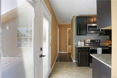 New French Doors lead to paved patio.
