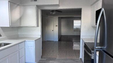 Kitchen with white cabinetry, ceiling fan, light s