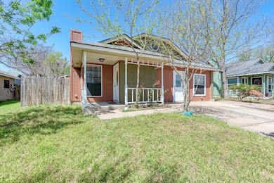 View of front of house with a front yard, fence, 