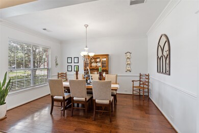 Formal dining room has gorgeous Hickory plank floors, chair rail and crown molding.