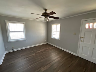 Foyer with baseboards, dark wood finished floors, 