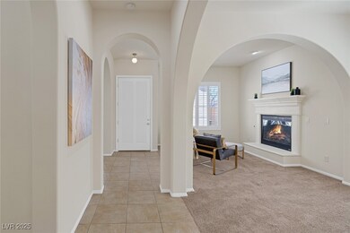 Corridor featuring light carpet, light tile patter