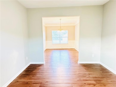 Unfurnished dining area featuring wainscoting, a n