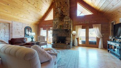Expansive open living and entertaining space, nice fireplace with Crab Orchard Stone, one of three fireplaces.