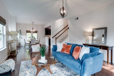 Inviting and open living & dining areas, beautiful floors, lots of window light