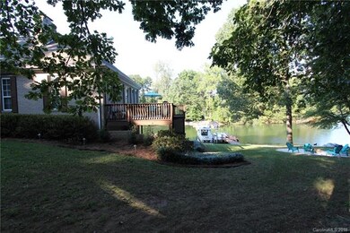 Side View of lake, deck, fire pit, and dock.