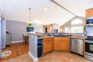 Vaulted Ceilings with hardwood floors and tiled kitchen