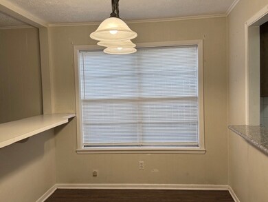 Unfurnished dining area with dark wood finished fl
