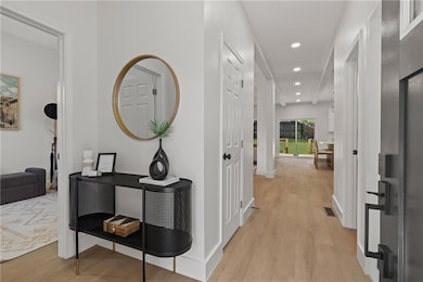 Hallway featuring light wood-style flooring and recessed lighting