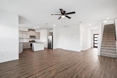 Unfurnished living room with dark wood-style floo