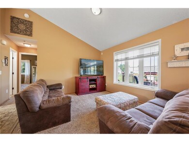 A spacious and light-filled living room offers vau