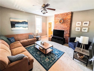 Spacious living room featuring a decorative brick