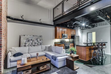 Living room featuring sink and brick wall