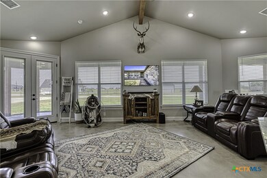 Living area with ceiling fan & beam ceiling
