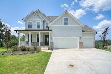 Craftsman inspired home with a garage, covered por