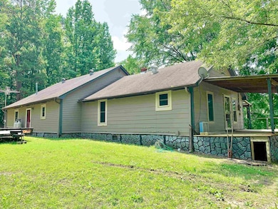 View of side of property featuring a yard