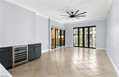 Unfurnished living room featuring wine cooler, ple