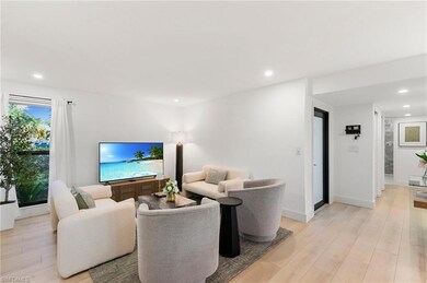 Living area with light wood-style flooring, basebo