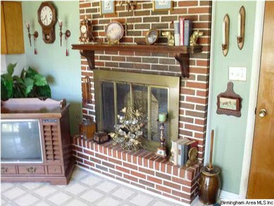 DEN HAS A MASONRY FIREPLACE WITH GAS LOGS