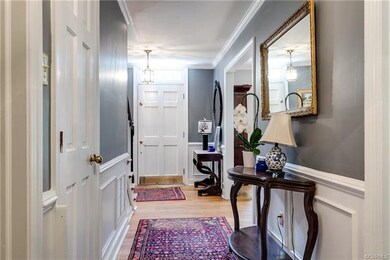 View of foyer looking back towards the front door - nice long hallway with direct access to all 4 main rooms on this level.  Great flow!