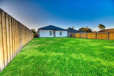 Back of house featuring a fenced backyard and a shingled roof