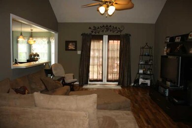 Cathedral ceiling in living room and french doors that lead out to the deck