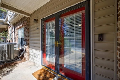 Doorway to property featuring central air conditio
