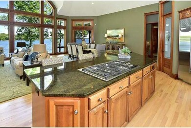 A roomy kitchen with lake views features a granite