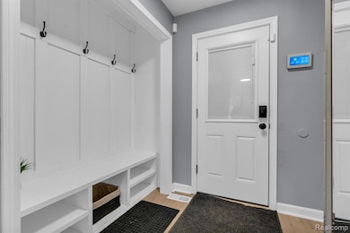Mudroom with light wood finished floors