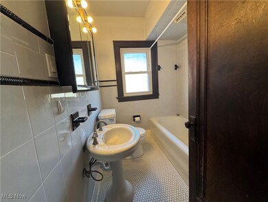Bathroom featuring separate shower and tub, tile patterned flooring, and tile walls
