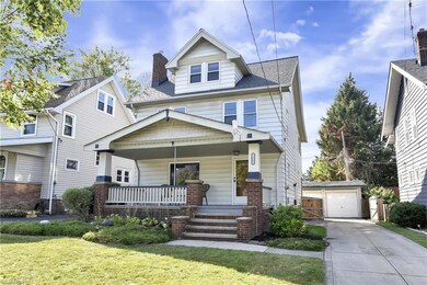 View of front of property with a porch and nicely landscaped front yard
