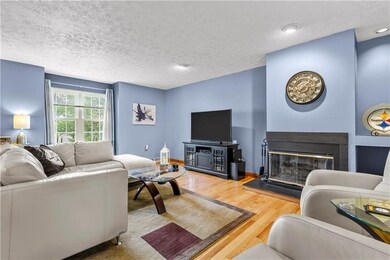 Bright cozy living room boasting hardwood floors, 
