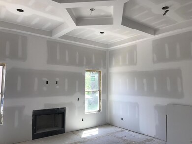 Living Room with beautiful coffered ceiling! This is the actual house under construction