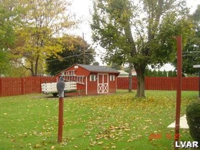Large yard with privacy fence and 12 x 16 storage 